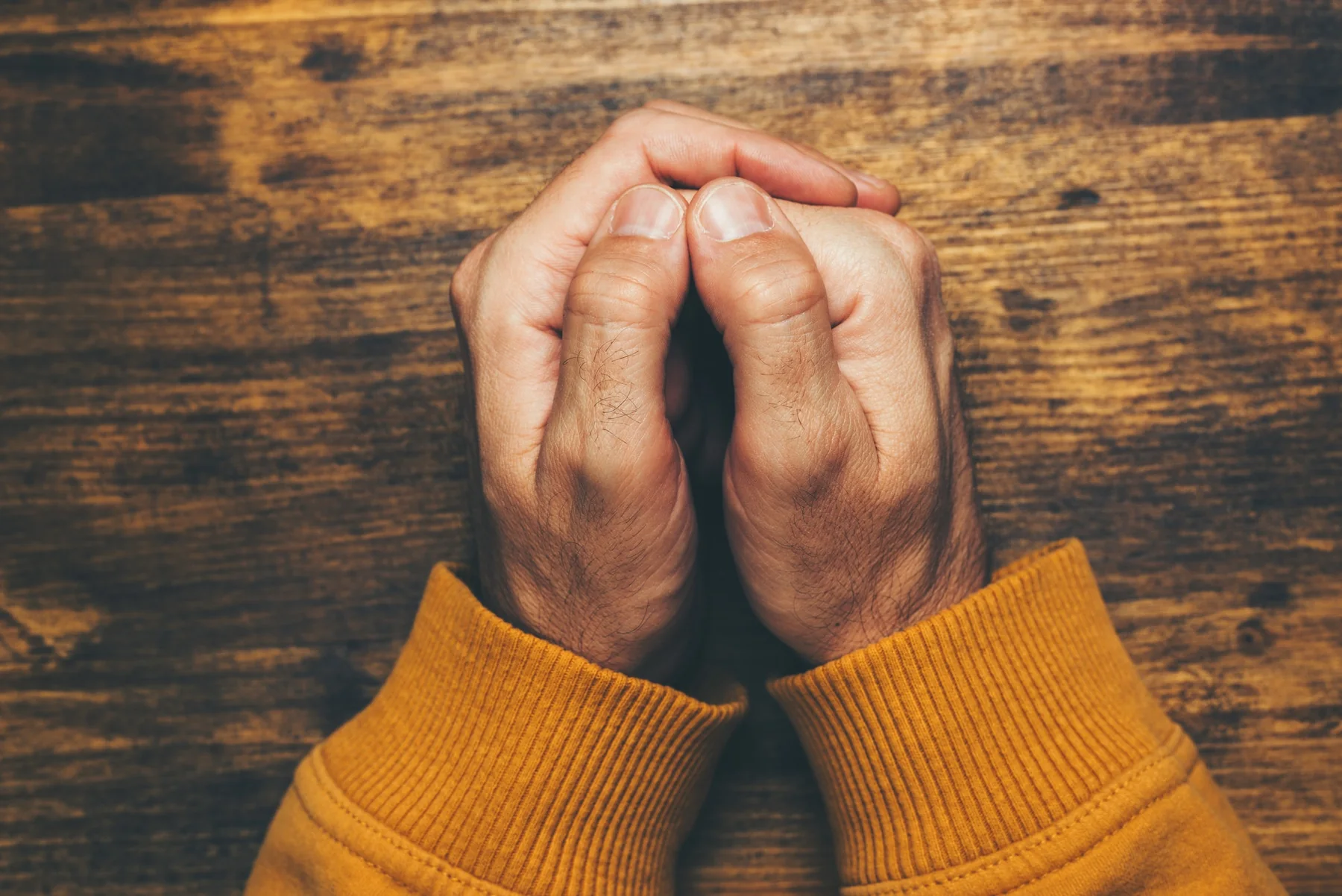 Hands clasped in prayer